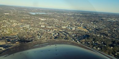 Aerial view of a coastal town with residential areas and water.